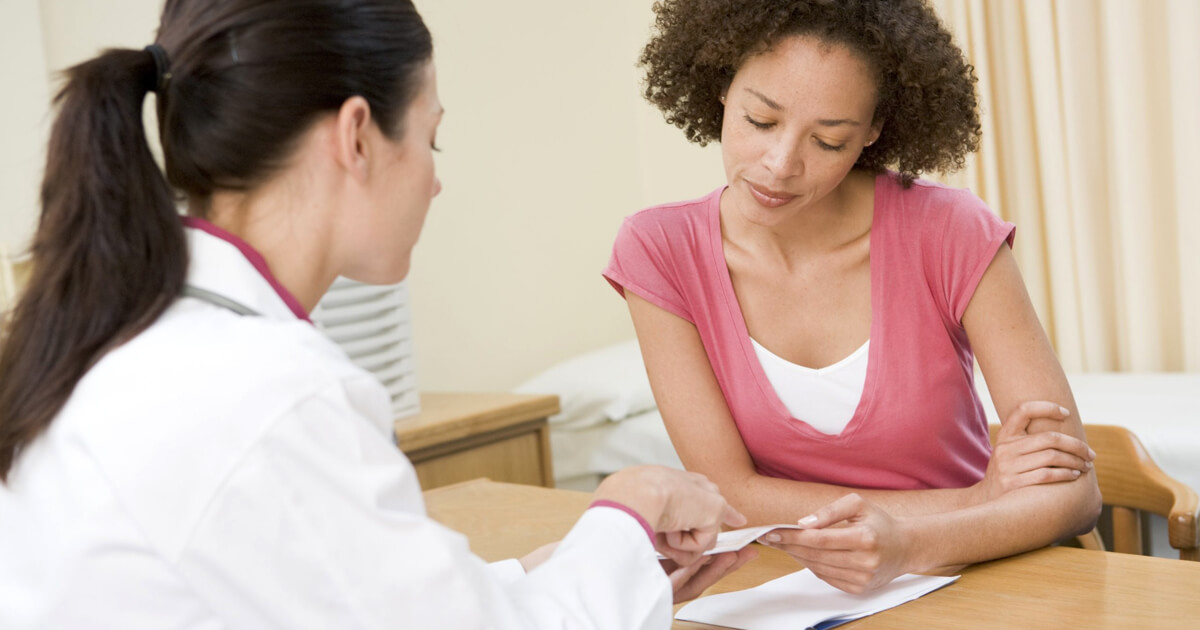 Woman and doctor reviewing family medical history