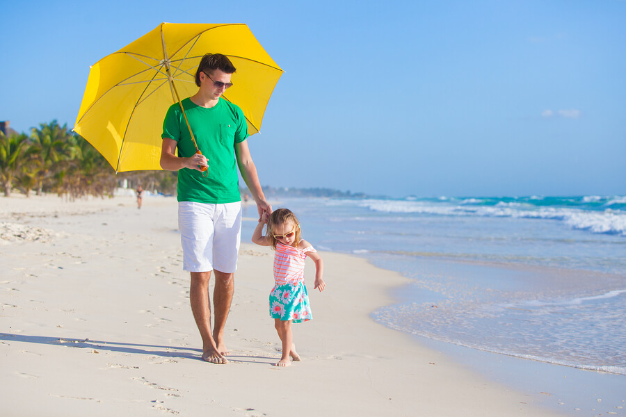 Family on the beach covering from sun rays