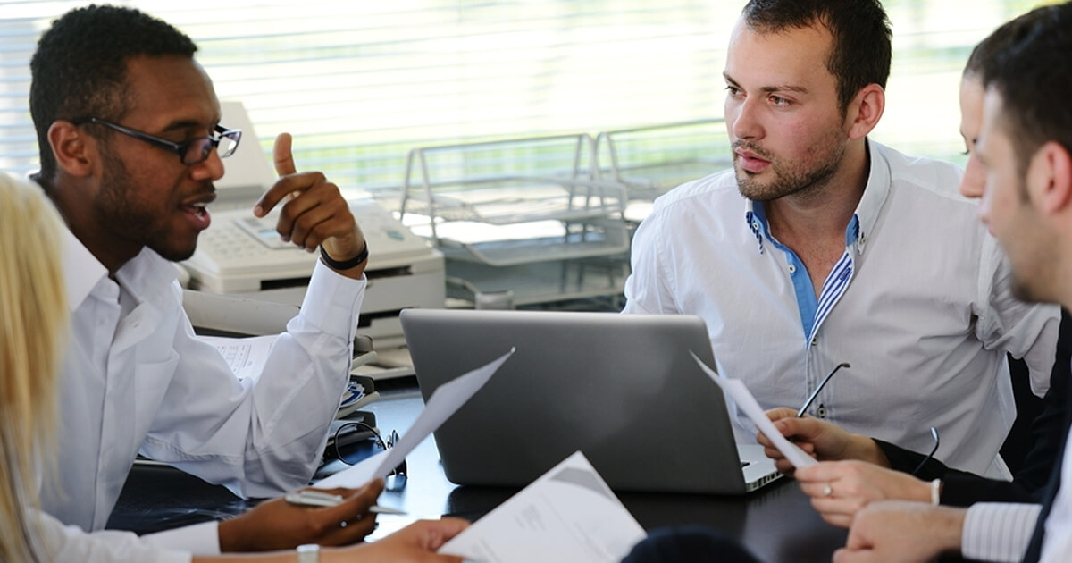 Workers discussing their great employee benefits